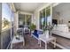 Inviting screened patio with brick flooring, comfortable seating, and a view of the adjacent living room at 8999 Croquet Ct, Davenport, FL 33896