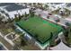Aerial view of a vibrant green sports field nestled within a community, perfect for soccer and other outdoor games at 8999 Croquet Ct, Davenport, FL 33896