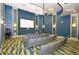 In-building theater with a projector, comfortable seating, and theater lighting, perfect for movies and entertainment at 8999 Croquet Ct, Davenport, FL 33896