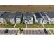 An aerial view of modern two-story homes featuring gray roofs, green lawns, and convenient parking spaces at 9190 Sommerset Hills Dr, Davenport, FL 33896