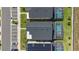 A bird's-eye view displays the backyard pools of upscale homes with dark roofs and meticulous landscaping at 9190 Sommerset Hills Dr, Davenport, FL 33896