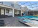 Backyard with pool, spa, covered patio, outdoor dining, lounge area and exterior TV at 9190 Sommerset Hills Dr, Davenport, FL 33896