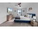 Cozy bedroom features a plush bed, dresser, and a mounted TV for relaxation at 9190 Sommerset Hills Dr, Davenport, FL 33896