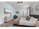 Bright bedroom with mounted TV, dresser, and blue accent chair at 9190 Sommerset Hills Dr, Davenport, FL 33896