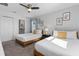 Inviting bedroom with two beds and a connecting bathroom, perfect for guests or Gathering at 9190 Sommerset Hills Dr, Davenport, FL 33896