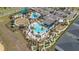 Aerial view showcasing a resort-style community pool, mini golf, waterslides and amenities at 9190 Sommerset Hills Dr, Davenport, FL 33896