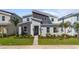 Modern two-story home boasts stylish gray stone, landscaped yard, and a welcoming front entrance at 9190 Sommerset Hills Dr, Davenport, FL 33896