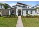 Modern two story home featuring a walkway, lawn, and landscaped front yard at 9190 Sommerset Hills Dr, Davenport, FL 33896