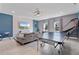 Spacious game room features a ping pong table and comfortable seating area with TV at 9190 Sommerset Hills Dr, Davenport, FL 33896