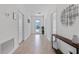 Bright hallway featuring neutral walls and floors leading to the front door at 9190 Sommerset Hills Dr, Davenport, FL 33896