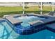 Closeup view of a backyard hot tub spa enclosed by a screened lanai at 9190 Sommerset Hills Dr, Davenport, FL 33896