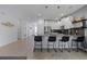 Modern kitchen with white cabinetry, a stylish backsplash, stainless appliances, and breakfast bar at 9190 Sommerset Hills Dr, Davenport, FL 33896