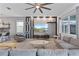 Beautiful living room featuring a large sectional couch, statement wall, and open layout to kitchen at 9190 Sommerset Hills Dr, Davenport, FL 33896