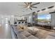 Spacious living room features modern design, large sectional, and open floorplan to kitchen at 9190 Sommerset Hills Dr, Davenport, FL 33896