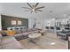 Open-concept living area with modern decor, comfortable seating, and seamless flow into dining and kitchen at 9190 Sommerset Hills Dr, Davenport, FL 33896