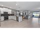 Open-concept living space boasts a stylish kitchen and comfortable living area with pool access at 9190 Sommerset Hills Dr, Davenport, FL 33896