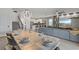 Expansive living and dining area with modern finishes, open to kitchen and stairwell to the second floor at 9190 Sommerset Hills Dr, Davenport, FL 33896