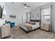 Cozy main bedroom with neutral walls, a ceiling fan, and a large window for natural light at 9190 Sommerset Hills Dr, Davenport, FL 33896