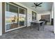 Covered patio with a dining table for six and a sliding glass door to the interior at 9190 Sommerset Hills Dr, Davenport, FL 33896
