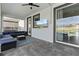 Covered patio with outdoor seating, exterior TV, sliding glass door and backyard views at 9190 Sommerset Hills Dr, Davenport, FL 33896