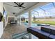 Relaxing covered patio with outdoor seating, dining area, view of the pool and backyard at 9190 Sommerset Hills Dr, Davenport, FL 33896