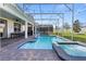 View of the pool, spa, backyard, and patio with covered dining area under lights at 9190 Sommerset Hills Dr, Davenport, FL 33896