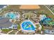An aerial shot captures a fun community waterpark featuring slides, splash pads, and lounge areas at 9190 Sommerset Hills Dr, Davenport, FL 33896