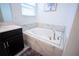 Close-up view of the elegant soaking tub with marble surround, and modern fixtures at 1025 Leader St, Davenport, FL 33896