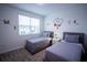 Charming bedroom with two twin beds, cartoon-themed wall decor and a bright window at 1025 Leader St, Davenport, FL 33896