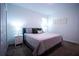 Comfortable bedroom features a queen-sized bed, neutral color scheme, and a bedside table with a lamp at 1025 Leader St, Davenport, FL 33896