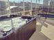 Outdoor hot tub in screened lanai with chairs for relaxation, surrounded by residential views at 1025 Leader St, Davenport, FL 33896