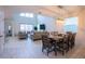 Open-concept living area with dining table, modern lighting, and neutral-toned furnishings at 1025 Leader St, Davenport, FL 33896