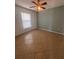 Bedroom with neutral walls, tile flooring, and a ceiling fan at 1149 E Grove Ave, Lake Wales, FL 33853
