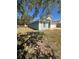 Single-story home with a two car garage and a well-maintained, grassy front lawn at 1149 E Grove Ave, Lake Wales, FL 33853