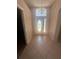 Light and airy foyer featuring tiled floors, decorative chandelier, and front door with sidelights at 1149 E Grove Ave, Lake Wales, FL 33853