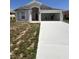 Charming single-story home with an open garage and well-lit facade at 1149 E Grove Ave, Lake Wales, FL 33853