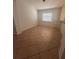 Open-concept living space with large window allowing for lots of natural light at 1149 E Grove Ave, Lake Wales, FL 33853