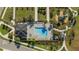 Aerial view of a community pool, playground, and lush green landscaping and walkways at 1153 Augustus Dr, Davenport, FL 33896