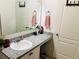 Cozy bathroom featuring a granite countertop, a sink, and stylish decor accents at 1153 Augustus Dr, Davenport, FL 33896