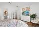 Bright bedroom with a full bathroom, decorative art, and a comfortable chair at 1153 Augustus Dr, Davenport, FL 33896