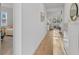 Bright hallway featuring access to the rooms, white walls, and plank floors at 1153 Augustus Dr, Davenport, FL 33896