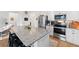 Modern kitchen with stainless steel appliances, granite countertops, and a large center island with seating at 1153 Augustus Dr, Davenport, FL 33896