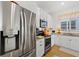 Well-equipped kitchen features stainless steel appliances, granite countertops, and white cabinetry at 1153 Augustus Dr, Davenport, FL 33896