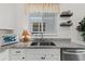 Bright kitchen with stainless steel appliances, granite countertops, and window view at 1153 Augustus Dr, Davenport, FL 33896