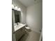 Modern bathroom with a single sink vanity, neutral color scheme, and glass-enclosed shower at 12673 Yoshino Aly, Orlando, FL 32827