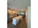 Modern kitchen with granite countertops, stainless steel appliances, and a large center island with seating at 12673 Yoshino Aly, Orlando, FL 32827