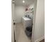 A cozy laundry room includes a washer, dryer, and shelving for added convenience at 12673 Yoshino Aly, Orlando, FL 32827