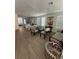 Open-concept living and dining area featuring wood floors, ample natural light, and contemporary furnishings at 12673 Yoshino Aly, Orlando, FL 32827