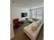 Comfortable living room featuring a white sofa, a TV, and plenty of natural light from the windows at 12673 Yoshino Aly, Orlando, FL 32827
