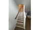 Staircase features wood treads and a white risers that complement the adjacent flooring at 12673 Yoshino Aly, Orlando, FL 32827